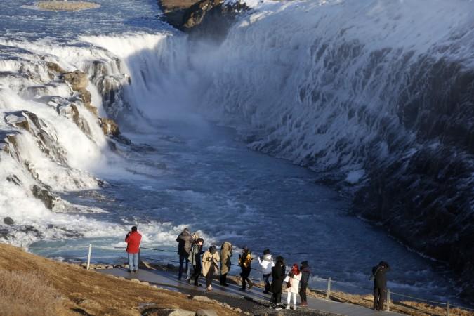 GULLFOSS WATERFALL: People walk near Gullfoss waterfall in southwestern Iceland. The waterfall is one of the most popular tourist attraction places in Iceland. Spectacular Waterfalls in the World