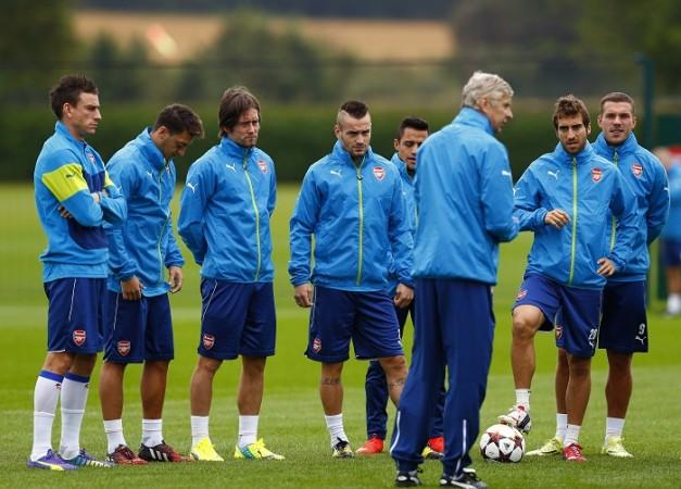 Arsenal manager Arsene Wenger talks to his players during a training session Arsenal Wenger
