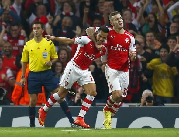 Arsenal forward Alexis Sanchez celebrates with Jack Wilshere after scoring the winner against Besiktas in their Champions League game Alexis Sanchez Jack Wilshere Arsenal