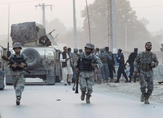 Afghan security forces arrive at the site of an attack in the city of Jalalabad August 30, 2014. At least six people were killed and dozens wounded when a suicide car bomber and Taliban gunmen attacked an office of the Afghan intelligence agency in the ea