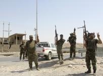 Iraqi security forces and Iraqi Shi'ite volunteers react after breaking a siege by the Islamic State extremist group on Amerli August 31, 2014.