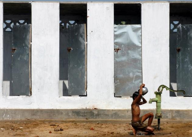 Modi said BJP got toilets built for the poor. (Representational image) A boy takes bath outside newly built toilets in a village