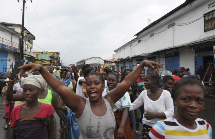 Crowds sang and danced in the streets of the seaside neighbourhood of West Point in Monrovia. Ebola Curfew