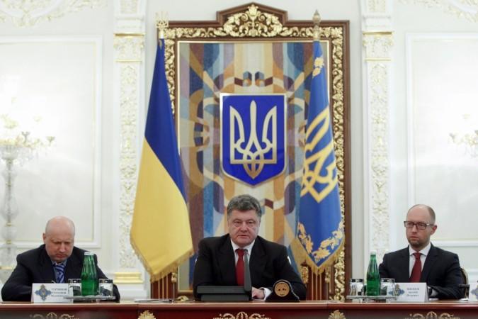 Ukrainian President Petro Poroshenko (C), Prime Minister Arseny Yatseniuk (R) and Head of Parliament (Verkhovna Rada) Oleksandr Turchynov take part in a meeting of the Security Council in Kiev on 28 August 2014. Ukraine has accused Russia of launching the greatest war after the Second World War.