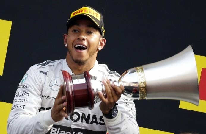 Mercedes Formula One driver Lewis Hamilton of Britain celebrates on the podium after winning the Italian F1 Grand Prix in Monza September 7, 2014. Lewis Hamilton