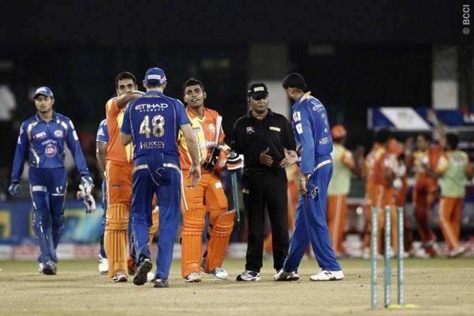 Umar Akmal shakes hands with Michael Hussey after guiding the Lahore Lions to a victory over the Mumbai Indians in their CLT20 2014 match Lahore Lions Umar Akmal Mumbai Indians Hussey Harbhajan