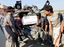 People carry a remnant of a war plane that crashed on the outskirts of Raqqa in northeast Syria September 16, 2014.
