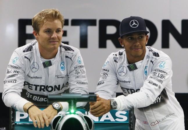 Mercedes drivers Nico Rosberg (L) and Lewis Hamilton pose for photos in their garage ahead of the Singapore F1 Grand Prix Lewis Hamilton Nico Rosberg Mercedes