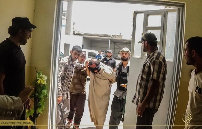 A blind-folded prisoner being brought in at the Mosul jail set up by the Islamic state police. A blind-folded prisoner being brought in at the Mosul jail setup by the Islamic state police.