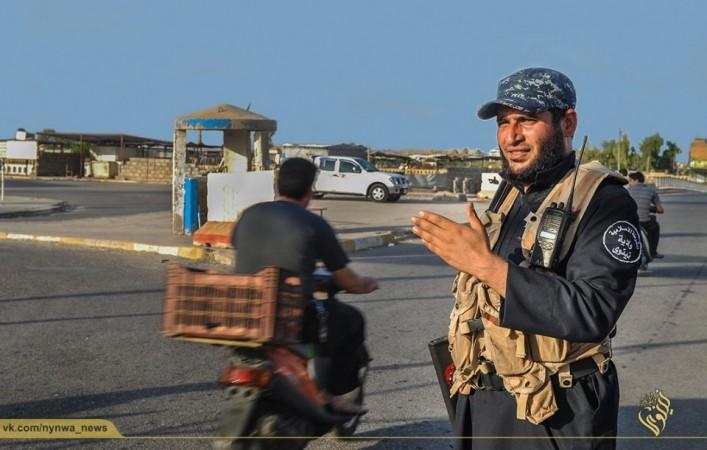 An ISIS army police mans a traffic junction in Mosul An ISIS army police mans a traffic junction in Mosul