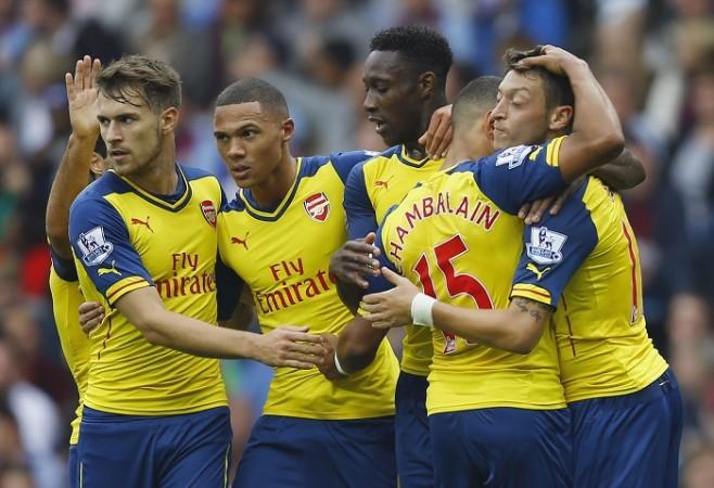 Arsenal playmaker Mesut Ozil celebrates with his teammates after scoring the opening goal against Aston Villa in their English Premier League game Arsenal Mesut Ozil Oxlade-Chamberlain Welbeck Gibbs Ramsey