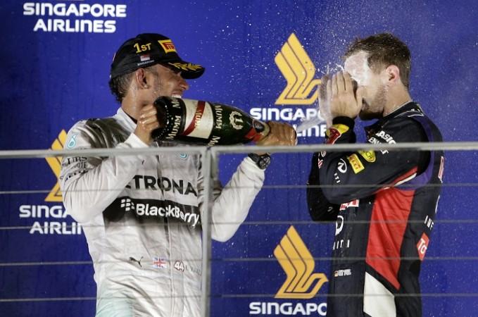 Race winner Lewis Hamilton douses runner-up Sebastian Vettel with champagne during the victory ceremony at the F1 Singapore GP Lewis Hamilton Sebastian Vettel Mercedes Red Bull Singapore GP