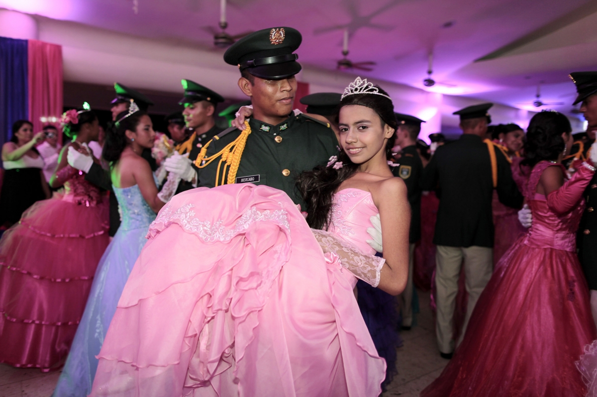 A cancer patient dances with a cadet from Nicaragua's Military Academy during her Quinceanera