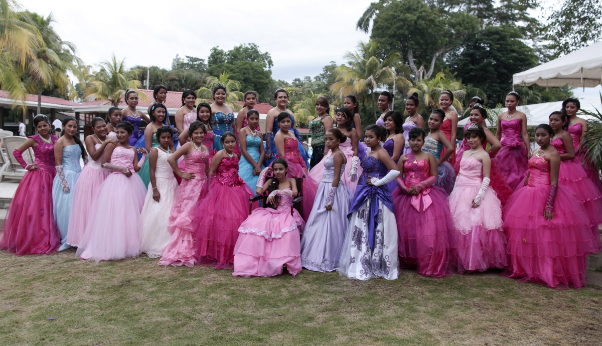 Female cancer patients pose for a group photo during their Quinceanera party at a hotel in Managua on 20 September 2014.