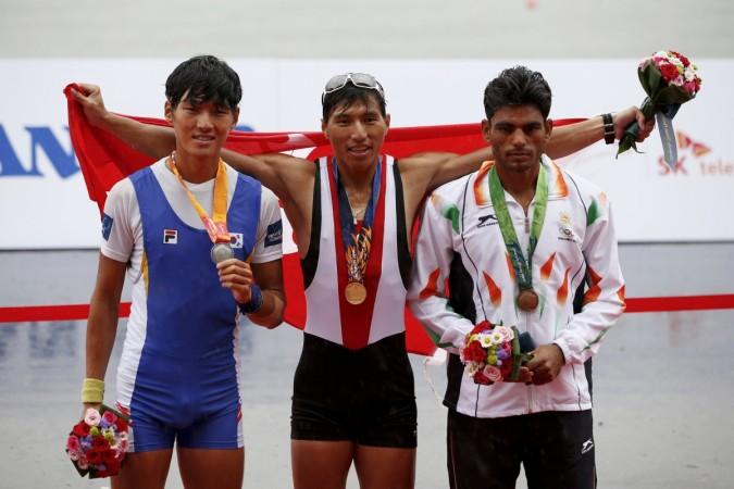 Gold medallist Hong Kong's Lok Kwan Hoi (C) poses with silver medallist South Korea's Lee Hak-beom (L) and bronze medallist India's Dushiant Dushyant after the final of the lightweight men's single sculls event of the rowing competition at the Chungju Tangeum Lake Internationl Rowing Center. dushyant