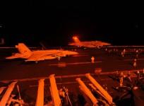 An F/A-18E Super Hornet, attached to Strike Fighter Squadron (VFA) 31, and an F/A-18F Super Hornet, attached to Strike Fighter Squadron (VFA) 213, prepare to launch from the flight deck of the aircraft carrier USS George H.W. Bush (CVN 77) to conduct stri