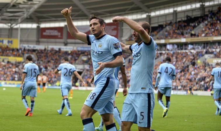 Manchester City's Frank Lampard (18) acknowledges the crowd with teammate Pablo Zabaleta (5) after scoring a goal during their English Premier League match against Hull City at the KC Stadium Manchester City