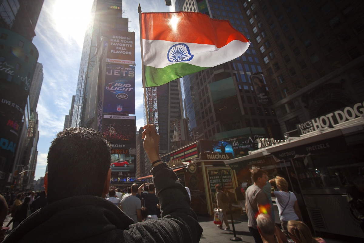A man waves the Indian flag at times Square ahead of Modi's address at Madison Square Garden Narendra Modi