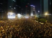 Tens of thousands of protesters block the main street to the financial Central district (at background) outside the government headquarters in Hong Kong September 28, 2014.