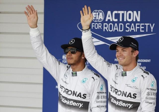 Nico Rosberg (R) waves to the crowd after finishing ahead of Mercedes teammate Lewis Hamilton in the qualifying session of the Japanese GP Lewis Hamilton Nico Rosberg Mercedes