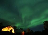 Aurora Borealis (Northern Lights) seen over a mountain camp north of the Arctic Circle