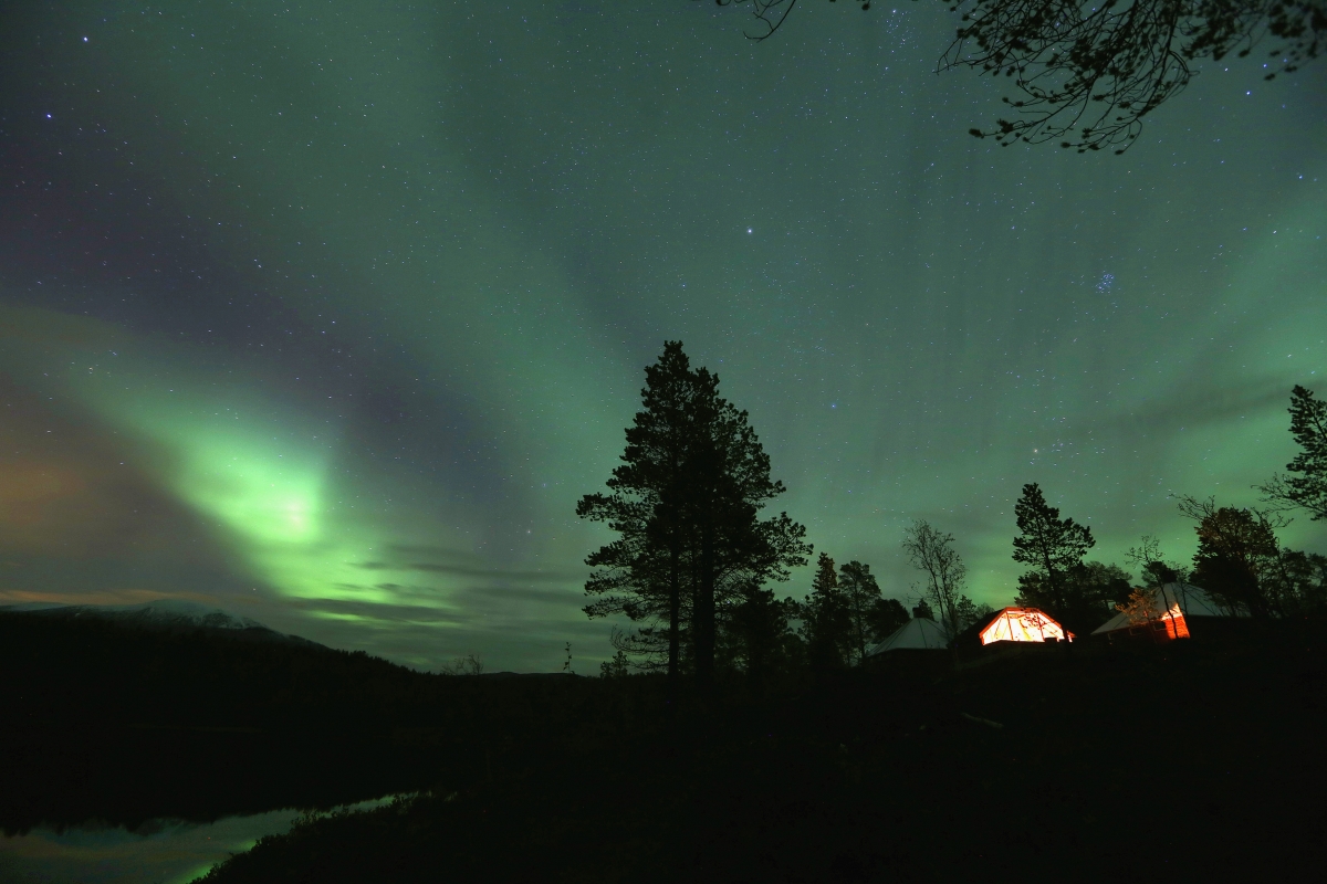 An Aurora Borealis (Northern Lights) is seen over a mountain camp north of the Arctic Circle, near the village of Mestervik early October 1, 2014. Aurora Borealis (Northern Lights) seen over a mountain camp north of the Arctic Circle