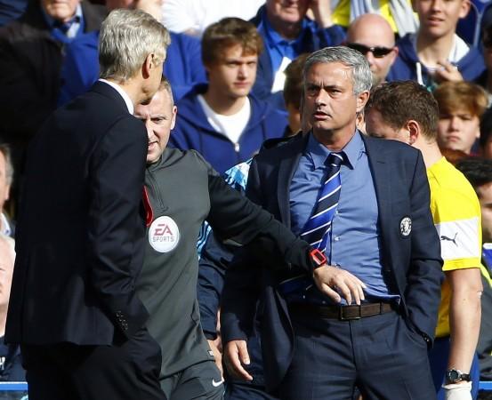 Chelsea manager Jose Mourinho (R) and his Arsenal counterpart Arsene Wenger (L) react during their English Premier League soccer match at Stamford Bridge Arsene Wenger