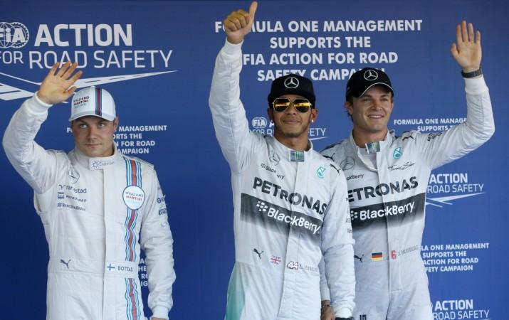 Williams Formula One driver Valtteri Bottas of Finland (L), Mercedes Formula One driver Lewis Hamilton of Britain (C) and his team mate Nico Rosberg of Germany, celebrate after the qualifying session of the Russian F1 Grand Prix in the Sochi Autodrom circuit Russian Grand Prix