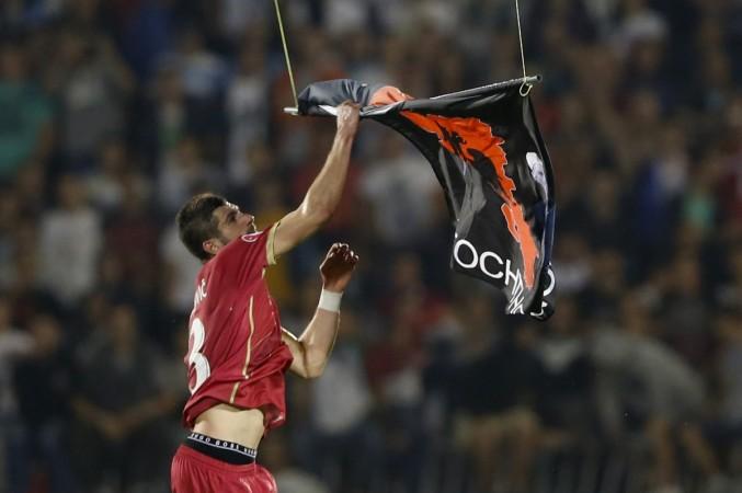 Stefan Mitrovic of Serbia grabs a flag depicting so-called Greater Albania, an area covering all parts of the Balkans where ethnic Albanians live, that was flown over the pitch during the Euro 2016 Group I qualifying soccer match between Serbia and Albania at the FK Partizan stadium Serbia vs Albania