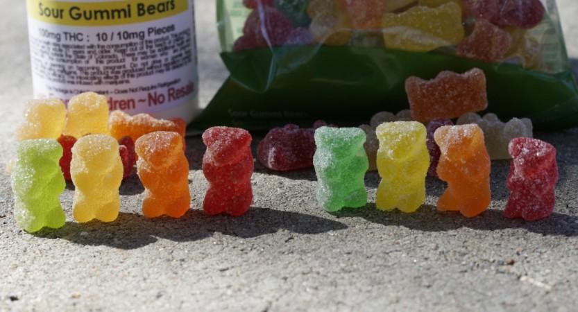 Marijuana-infused sour gummy bear candies next to refular ones Marijuana-infused sour gummy bear candies
