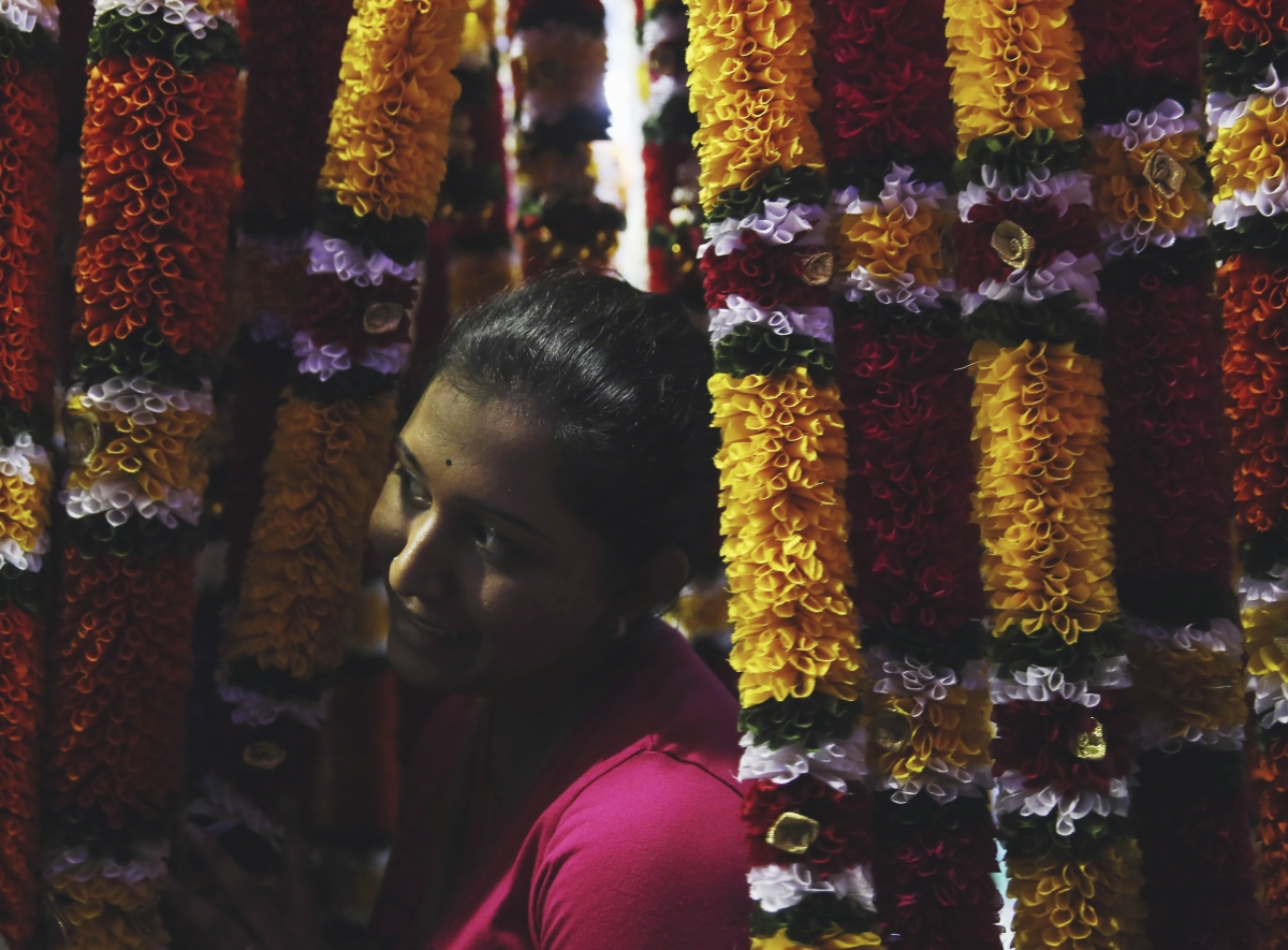 A woman shops for flower garlands ahead of Diwali celebrations in Kuala Lumpur, October 20, 2014.