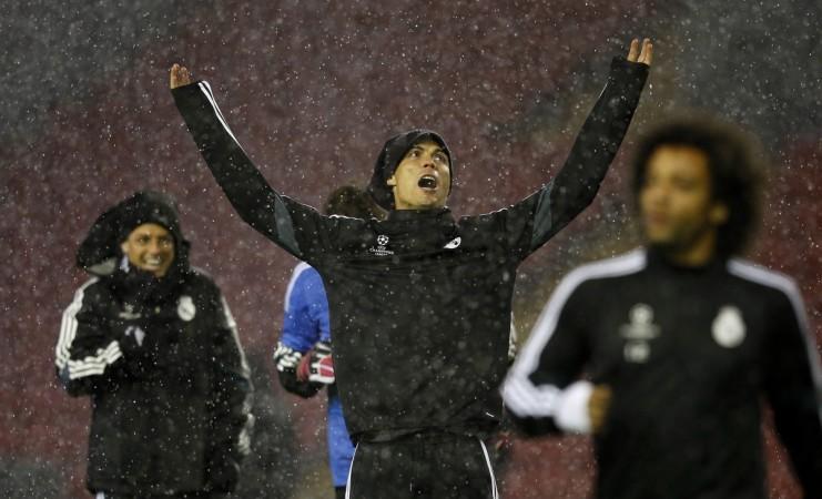 Real Madrid's Cristiano Ronaldo gestures as he stands in the rain during a training session at Anfield ahead of their Champions league clash against Liverpool Real Madrid
