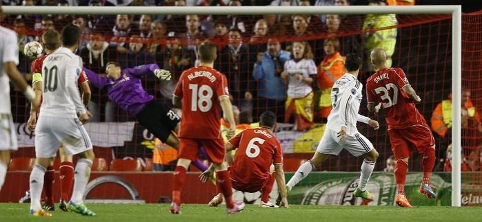 Real Madrid forward Cristiano Ronaldo scores past Liverpool goalkeeper Simon Mignolet in their Champions League game Cristiano Ronaldo Real Madrid Martin Skrtel Liverpool
