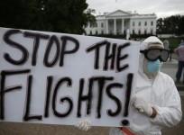 Protestor Jeff Hulbert of Annapolis, Maryland holds a sign reading ''Stop the Flights'' as he demonstrates in favor of a travel ban to stop the spread of the Ebola virus, in front of the White House in Washington.