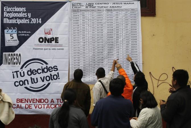 People check for their voting booths outside a public school during elections in Lima, Peru. A coin toss decided the mayoral race in Peru after two candidates tied at the ballot box Coin toss decided the mayoral race in Peru after two candidates tied at the ballot box