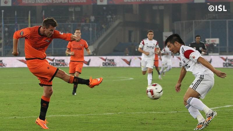 Delhi Dynamos' Mads Junker (L) has his shot blocked by NorthEast United's Robin Gurung. Delhi Dynamos vs NorthEast United