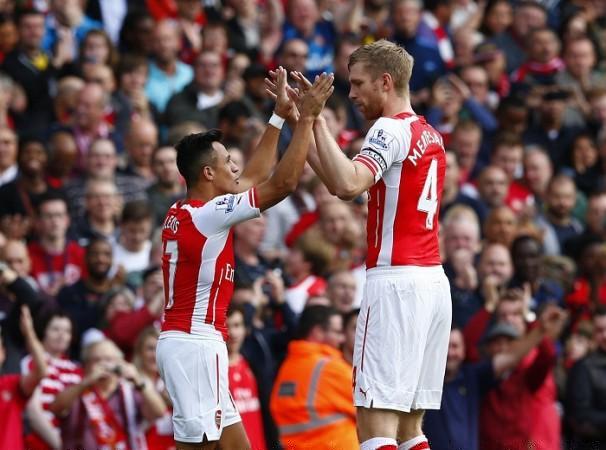 Arsenal forward Alexis Sanchez celebrates with Per Mertesacker after scoring against Hull City in their English Premier League game Arsenal Alexis Sanchez Per Mertesacker