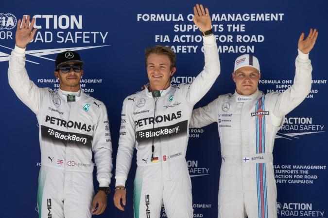 Mercedes drivers Nico Rosberg of Germany (C), team-mate Lewis Hamilton of Britain (L) and Williams driver Valtteri Bottas of Finland wave to fans and media, after completing the qualifying session of the F1 United States Grand Prix in Austin, Texas United States Grand Prix
