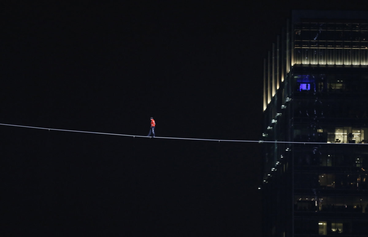 Daredevil Nik Wallenda walks along a tightrope between two skyscrapers