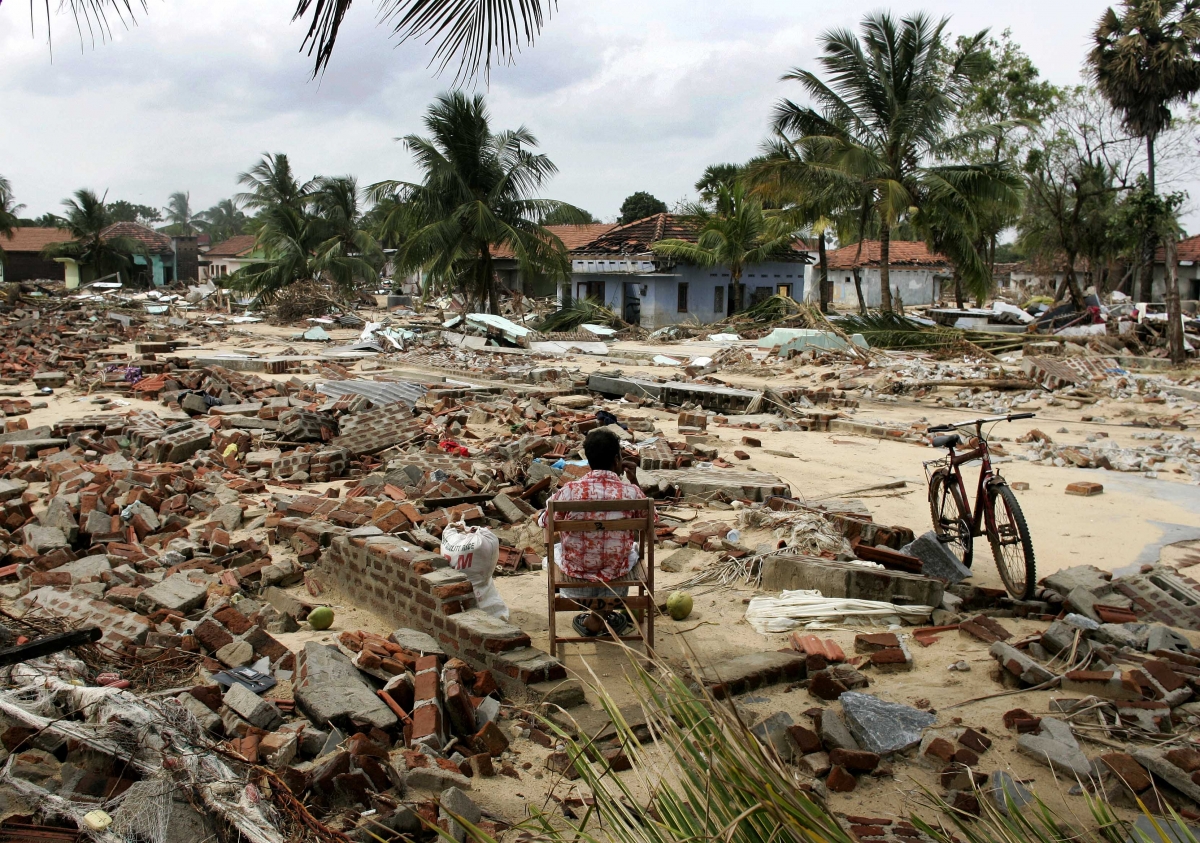 A man sits in the remains of his home that was destroyed in the December 26 tsunami in the village of Pandiruppu on Sri Lanka's east coast Waves of Tsunami 2004 destroyed countries and killed many people