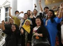 Activists celebrate overturning a sharia law against cross-dressing at the Appeals Court in the Palace of Justice in Putrajaya November 7, 2014.
