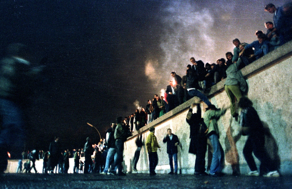 25th Anniversary of Berlin Wall's Fall. (Photo: East German citizens climb the Berlin wall at the Brandeburg gate after the opening of the East German border was announced, November 9, 1989.) 25th Anniversary of Berlin Wall's Fall: