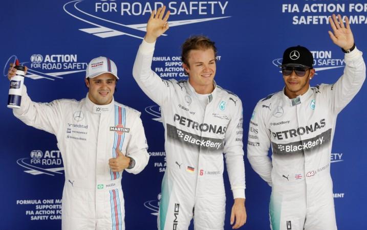 Mercedes Formula One drivers Nico Rosberg of Germany (C), team-mate Lewis Hamilton of Britain (R) and Williams Formula One driver Felipe Massa of Brazil wave to fans and media, after completing the qualifying session of the Brazilian Grand Prix in Sao Paulo, November 8. Brazilian Grand Prix