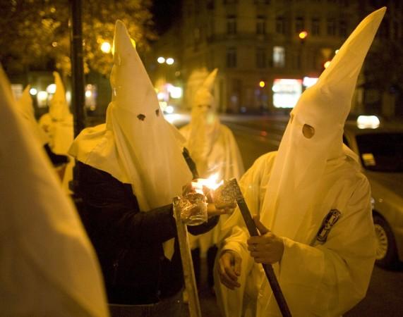 The white supremacist group 'Ku Klux Klan' is reportedly rebranding to including jews, black people and gays. (Photo: Supporters dressed as members of the Ku Klux Klan, using the occasion of Halloween to mask their faces from the police, light flares as they express anti-Semitic views in Lviv October 31, 2014) The white supremacist group 'Ku Klux Klan' is reportedly rebranding to including jews, black people and gays.