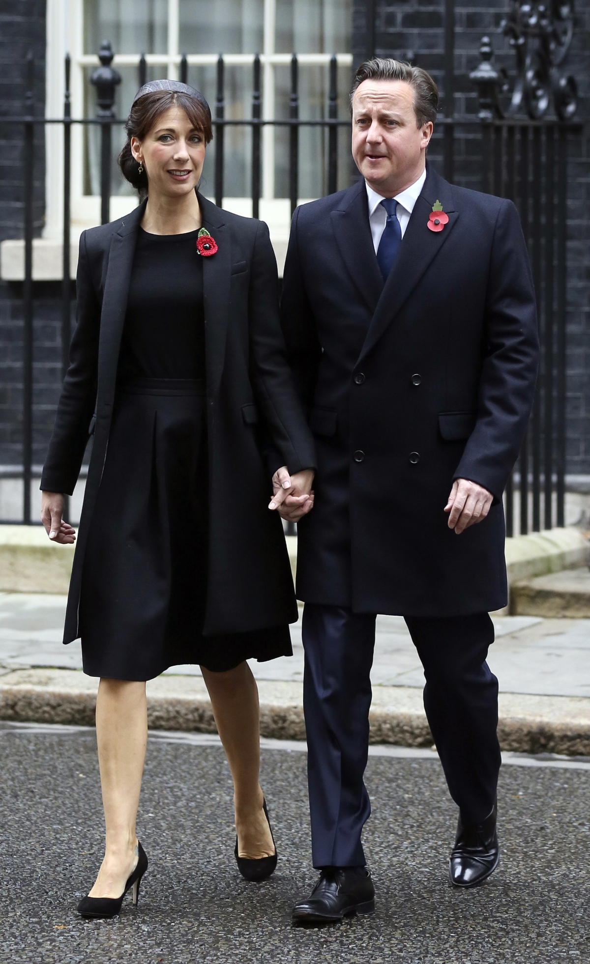 Britain's Prime Minister David Cameron and his wife Samantha leave Number 10 Downing Street to attend the Remembrance Sunday service at the Cenotaph in central London November 9, 2014. Britain's Prime Minister David Cameron