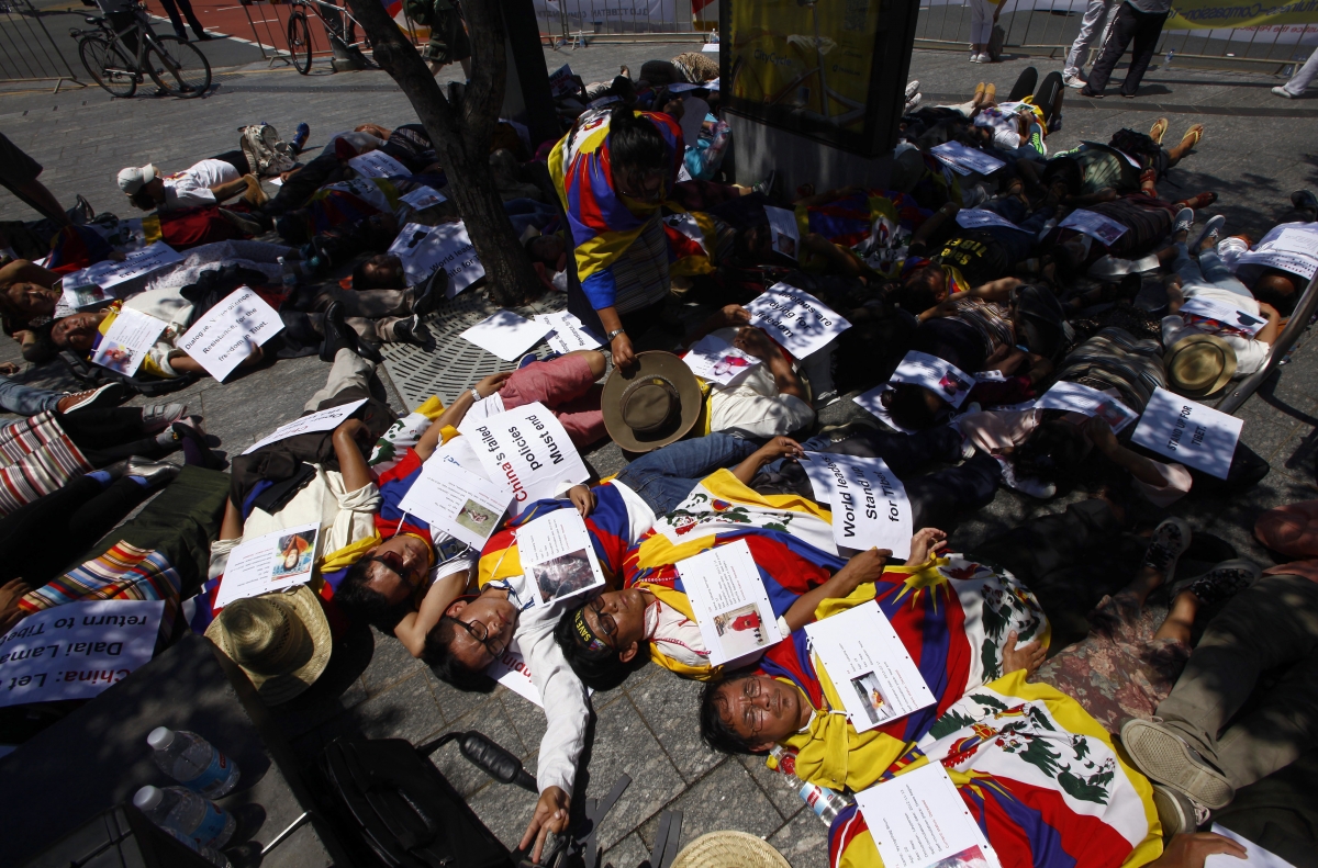 Protesters supporting an independent Tibet lie on the ground holding placards as they protest near the G20 Summit venue in Brisbane. G20 Summit 2014