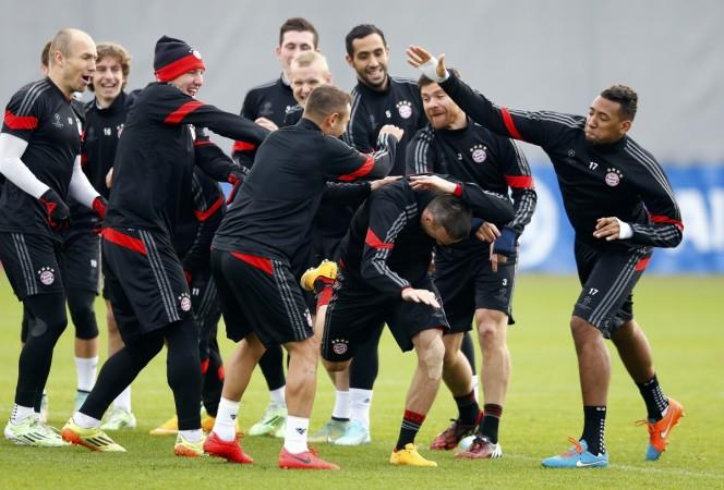 Bayern Munich players joke with Franck Ribery (2nd R, front) during a training session. Bayern Munich