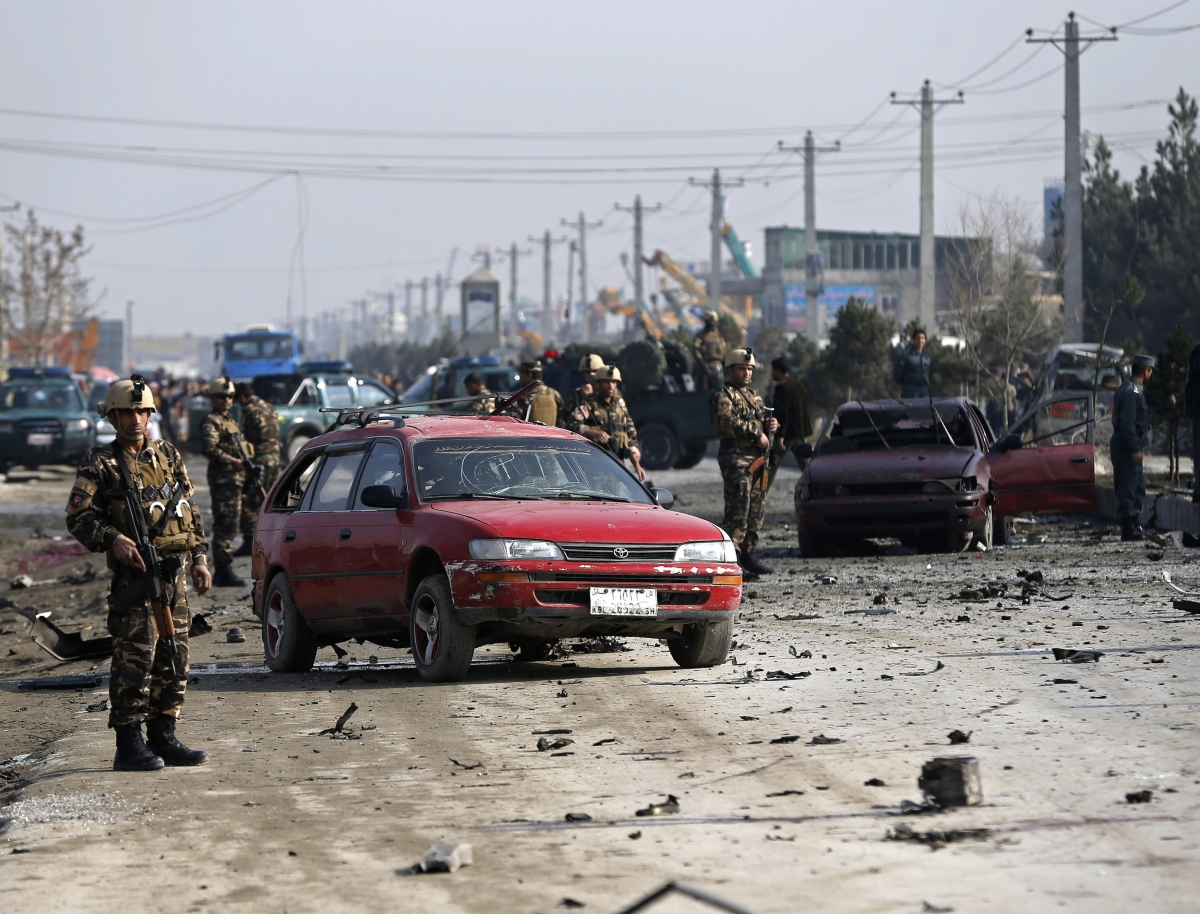 Afghan security forces inspect the site of a suicide attack on a British embassy vehicle in Kabul, November 27, 2014. Kabul Suicide Attack