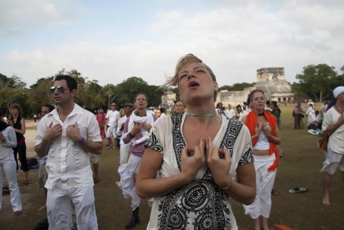 Tourists meditate at the archaeological zone of Chichen Itza in Yucatan State as the Earth survived a day billed by doomsday theorists as the end of the world and a new era began for the Maya people. Theologist Dr F. Kenston Beshore predicts end of the world in 7 years