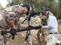 Rebel fighters prepare to fire a machine gun towards forces loyal to Syria's President Bashar al-Assad in the Jabal al-Akrad area in Syria's northwestern Latakia province November 25, 2014